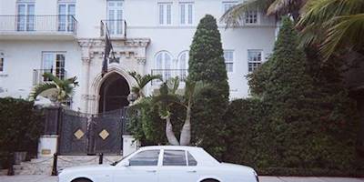 Rolls-Royce in Front of Mansion