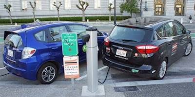 Ford C-Max Energi and Honda Fit EV at a public charging st ...