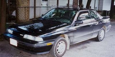 1990 Mazda MX-6 DX - shaded, dusty 3-quarter front view ...